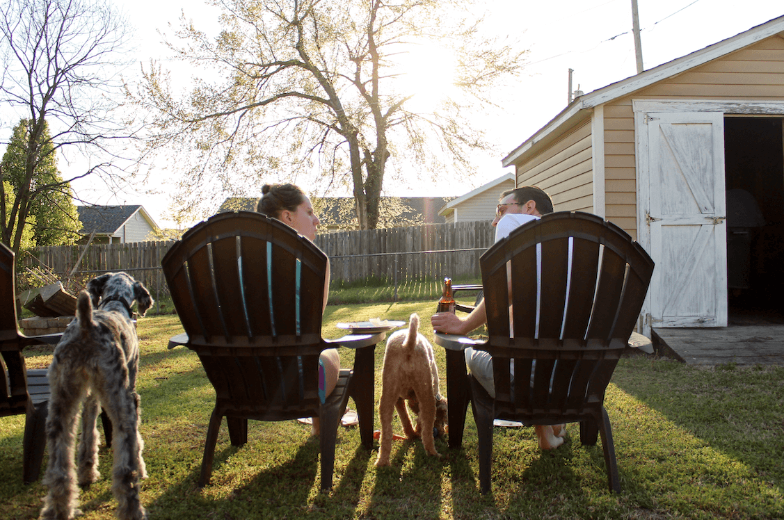 Couple and their dogs enjoying a South Dakota summer evening in their backyard.