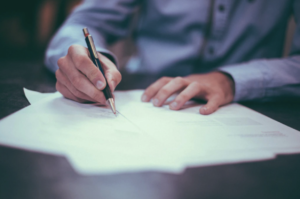 man filling out paperwork