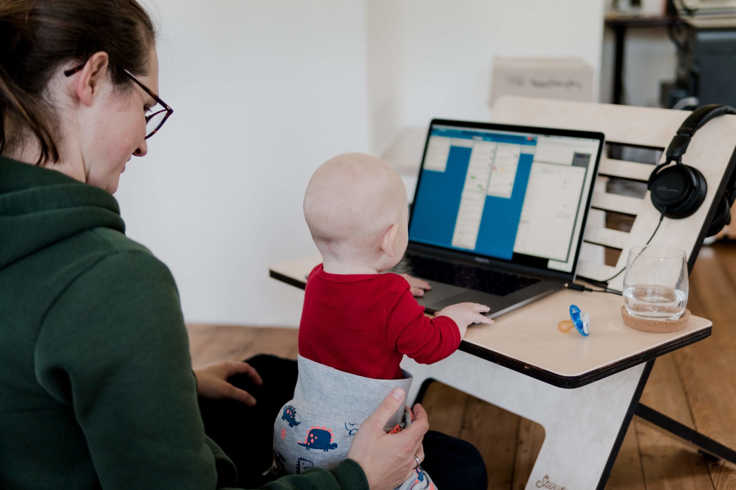 woman working at computer with infant